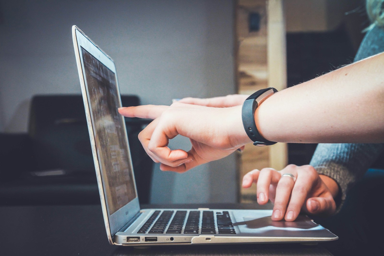 Conversion optimisation specialist reviewing A/B test results on multiple screens